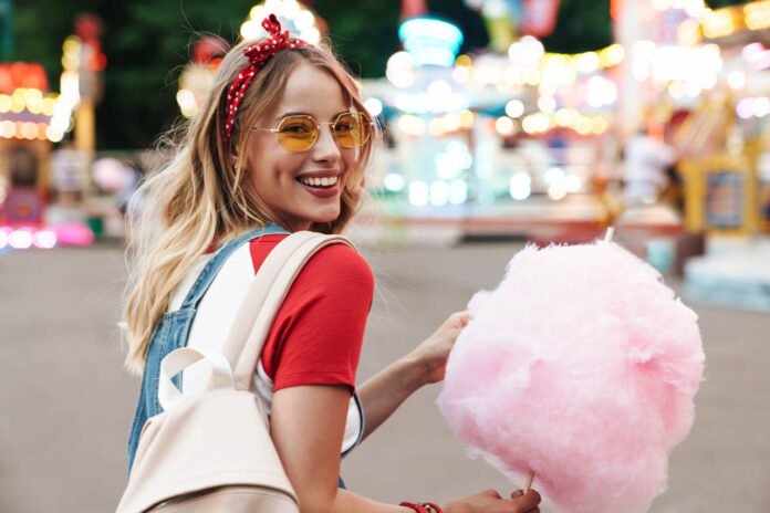 Image,Of,Smiling,Young,Woman,Wearing,Girlish,Clothes,Eating,Sweet